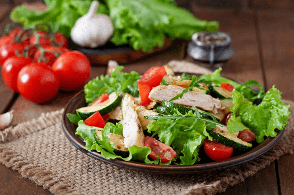 A salad with chicken and vegetables is a great option for a light dinner after training. 