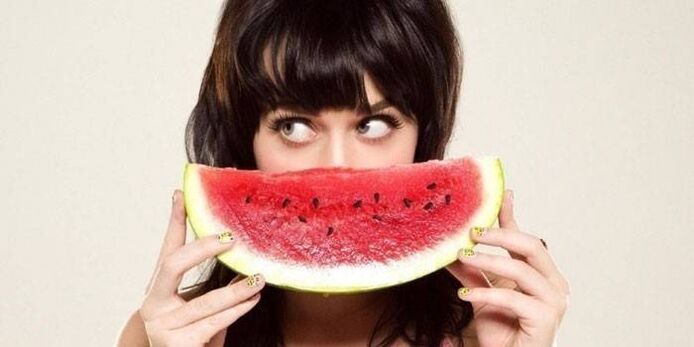a girl with a watermelon following a watermelon diet